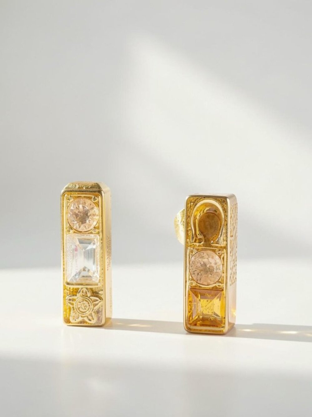 Coach Gold earrings with clear and pink gemstones